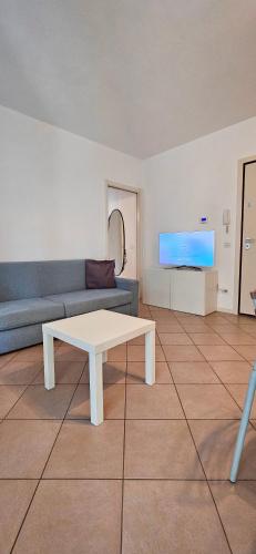 a living room with a couch and a table at APPARTAMENTO A DUE PASSI DAL MARE By VILLA FIORITA in Cattolica