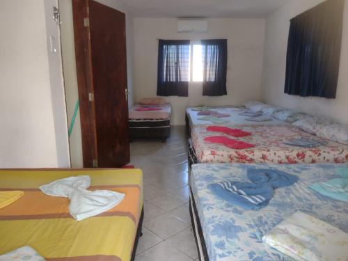 Ένα ή περισσότερα κρεβάτια σε δωμάτιο στο Hostel da terê