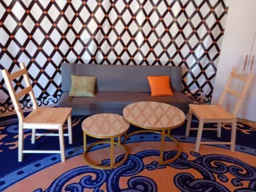 a room with a couch and two tables and two chairs at nice Glamping in Tappen