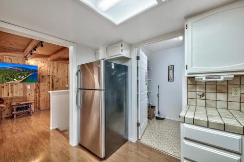 a kitchen with a stainless steel refrigerator and wooden walls at Mv15 lakeview top of the mountain townhome in Stateline
