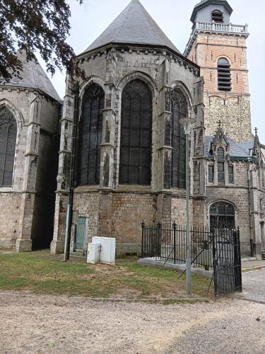 an old church with a gate in front of it at La chambre des daines in Binche