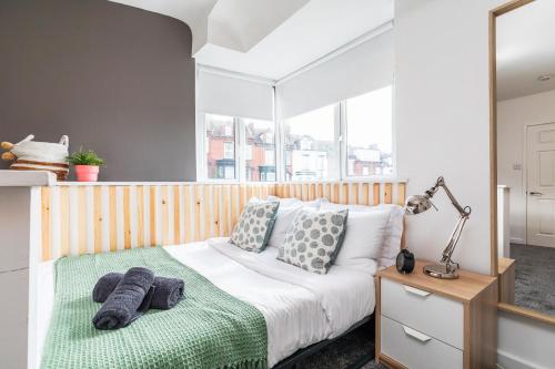 a bedroom with a white bed with pillows on it at Stylish Studio Apt in Leeds in Headingley