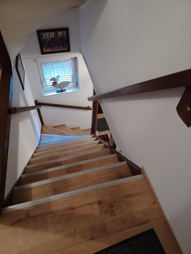 a staircase in a tiny house with a window at Ferienwohnung Teestube Wernigerode ANA in Wernigerode