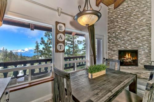 a dining room with a table and a fireplace at Mv17 amazing lake view spacious ski cabin in Stateline