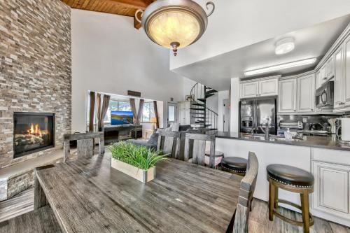 a kitchen and living room with a table and a fireplace at Mv17 amazing lake view spacious ski cabin in Stateline
