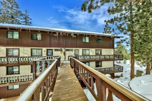 a resort building with a wooden walkway in the snow at Mv17 amazing lake view spacious ski cabin in Stateline