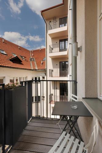 a balcony with a table and a building at Hotel Prokop Square in Prague