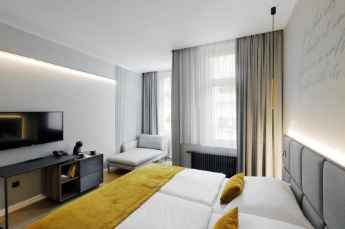 a hotel room with a bed and a chair at Hotel Prokop Square in Prague