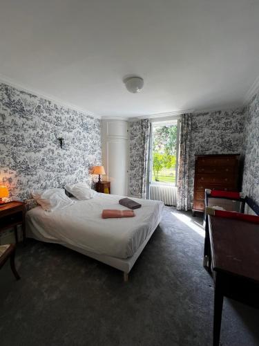 a bedroom with a bed and a large window at Le Chesnoy 17 pers piscine tennis in Parly