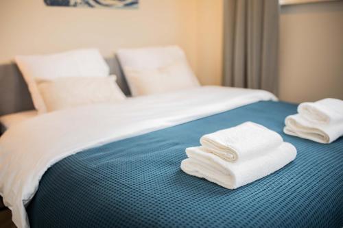 a bed with white towels on top of it at Kerkstraat in Hilversum