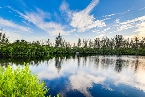 a lake with trees and clouds in the sky at Kayaks, Bikes and Bay Access Bradenton Escape! in Bradenton