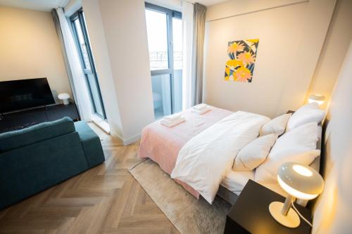 a bedroom with a large bed and a couch at Kerkstraat in Hilversum