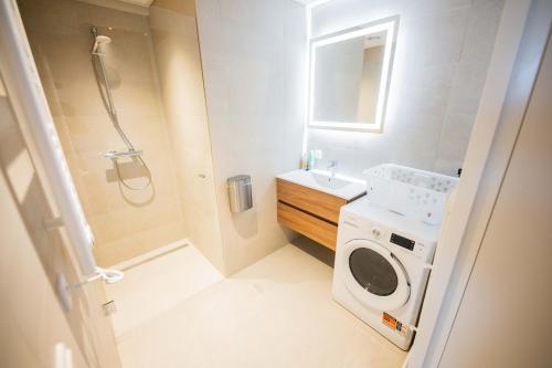 a bathroom with a sink and a washing machine at Kerkstraat in Hilversum