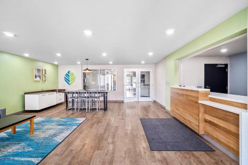 a living room with a kitchen and a dining room at WoodSpring Suites Fort Myers - Cape Coral in Fort Myers