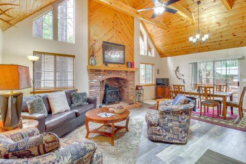 a living room with a couch and a fireplace at 4 Mi to Lake Pet-Friendly Cabin in Pinetop in Pinetop