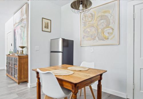 a dining room with a table and a refrigerator at 1BR Apt 8min St Anthony Monthly 15 Off #03C in Oklahoma City