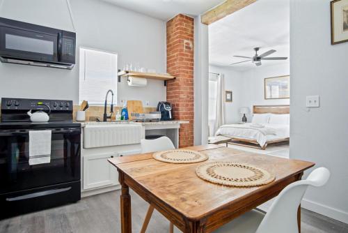 a kitchen and dining room with a wooden table at 1BR Apt 8min St Anthony Monthly 15 Off #03C in Oklahoma City