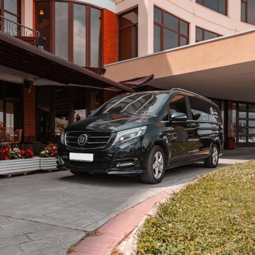 a black van parked in front of a building at Hotel Airport Tirana in Rinas