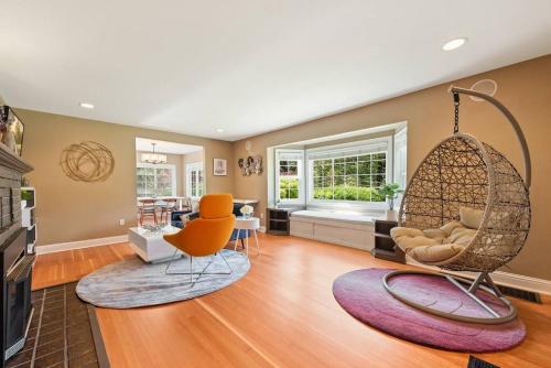 a living room with a swing chair and a living room at Private park in a cozy home next to I-90 huge yard in Mercer Island