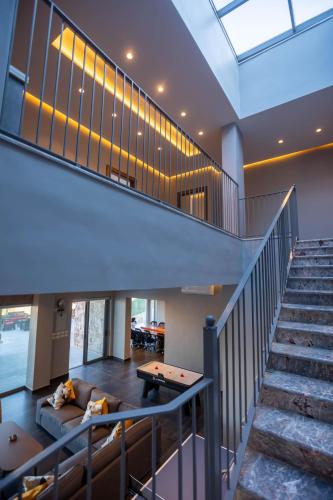 a staircase in a house with a pool table at Makanak Villas in Jerash