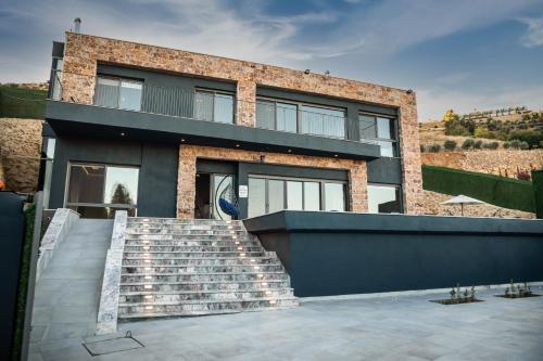 a brick house with stairs in front of it at Makanak Villas in Jerash