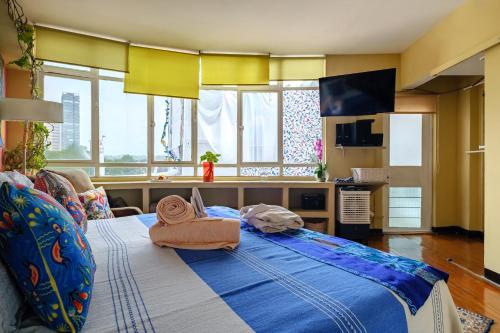 a bedroom with a large bed with towels on it at Casa Itzae B&B Polanquito Dog Friendly in Mexico City