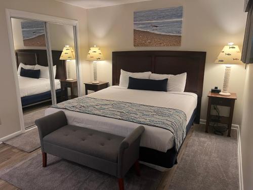 a bedroom with a bed and a chair in it at Summer Sands - 106 by Sea Scape Properties in Wrightsville Beach