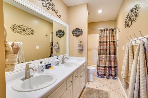 a bathroom with two sinks and a mirror at Near Silver Dollar City! Condo with Hot Tub and Lake in Branson