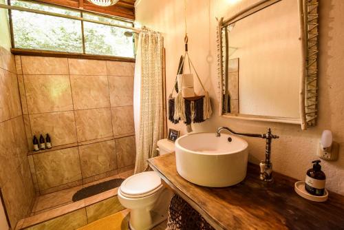 a bathroom with a sink and a toilet at UP! HOUSE Costa Rica ~ 2 Casitas in Playa Chiquita in Talamanca
