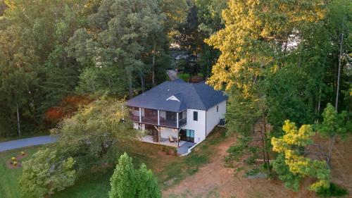 an aerial view of a house in the woods at The Birdhouse - Lake View with Dock in Mooresville