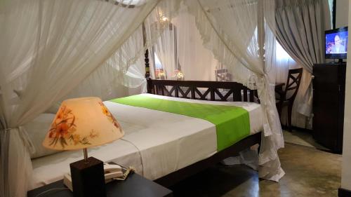 Кровать или кровати в номере Ridee Villa