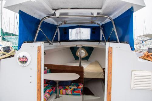 a small boat with a bed and a table at 70's Tiny Boat in Lisbon