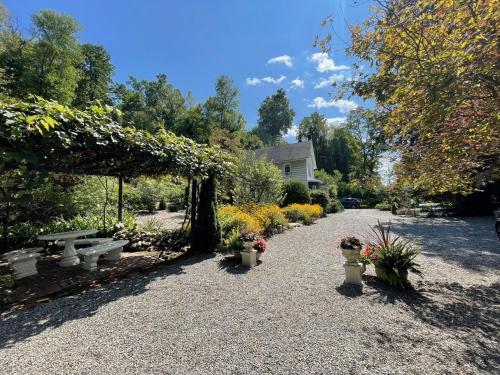 a garden with a group of benches and flowers at Beacon Hermitage in Beacon