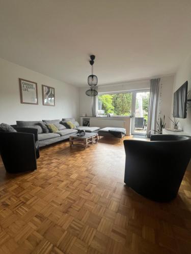 a living room with a couch and chairs in it at Moderne familienfreundliche Wohnung am Waldrand von Prüm mit Terrasse in Prüm