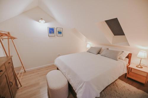 a bedroom with a large white bed in a attic at Stone House Zrinski entire apartment 62 m2 in Luka