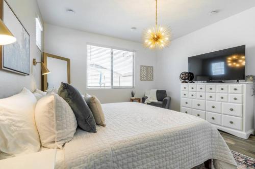 a bedroom with a large bed and a dresser at Private Pool! Avondale - Modern Mtn View Oasis in Cashion
