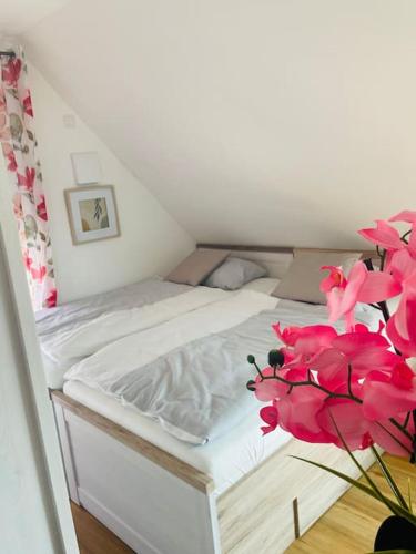a bedroom with a bed with pink flowers on it at Apartment Scholle Steinbeck in Recke