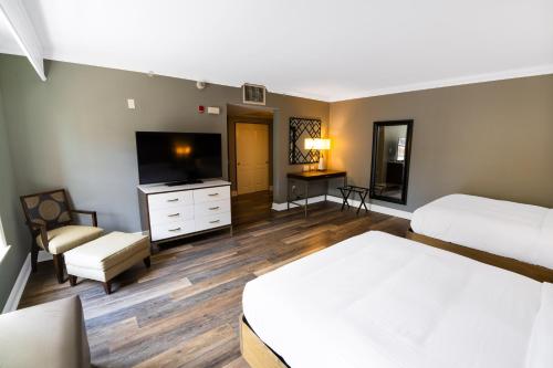 a hotel room with two beds and a flat screen tv at Hilton Saint Augustine Historic Bayfront in Saint Augustine