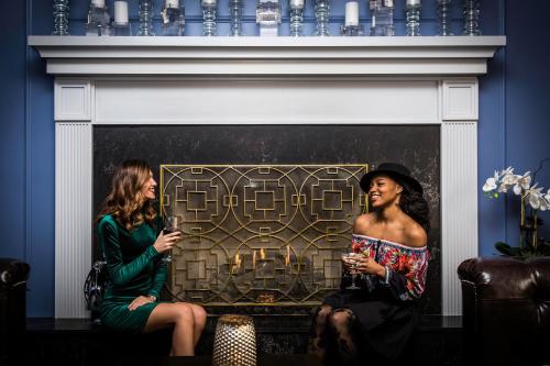 two women sitting in front of a fireplace at The Read House Hotel in Chattanooga