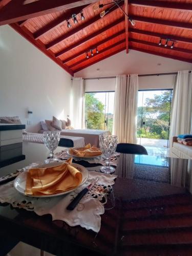a dining room table with plates of food on it at Cabanas Privativas com Jacuzzi, Cozinha, Churrasqueira e Decoração - Sitio Pauletto in Jarinu