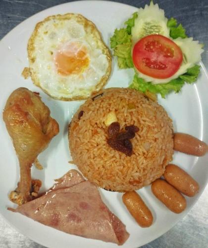 a plate of food with an egg and rice and vegetables at Tara Lake in Bangkok