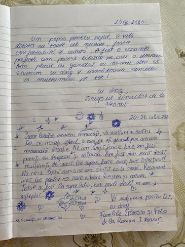 a letter written in blue handwriting on a sheet of paper at Casa Jeni in Suceava