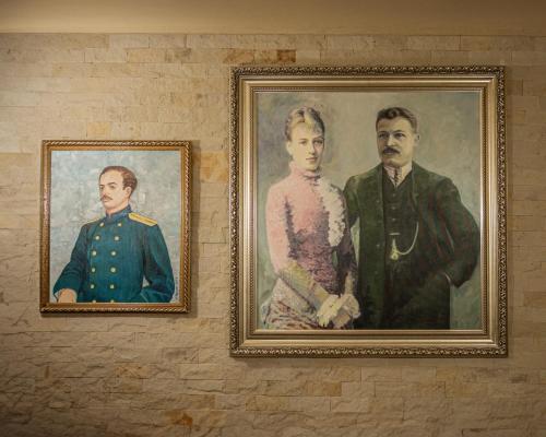 two portraits of a man and a woman on a wall at Castel Unghern in Ivancea