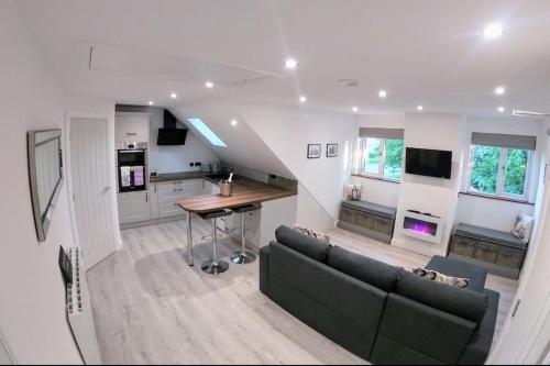 a living room with a couch and a table at Lavender Lodge - Modern apartment in York, near Racecourse in Copmanthorpe