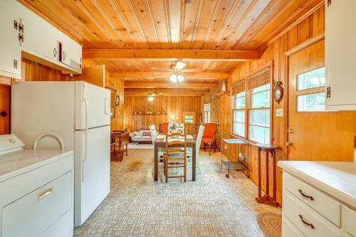 a kitchen with a refrigerator and a table with chairs at Peaceful Lumberton Home - 7 Mi to Dtwn Riverwalk! in Lumberton