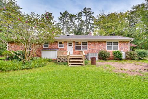 a brick house with a lawn in front of it at Peaceful Lumberton Home - 7 Mi to Dtwn Riverwalk! in Lumberton