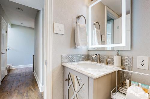 a bathroom with a sink and a mirror at 104 World of Tennis Square #104 in Lakeway