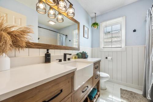 a bathroom with a sink and a mirror at Feel at Home a 3 Minute Walk from the Beach in Myrtle Beach
