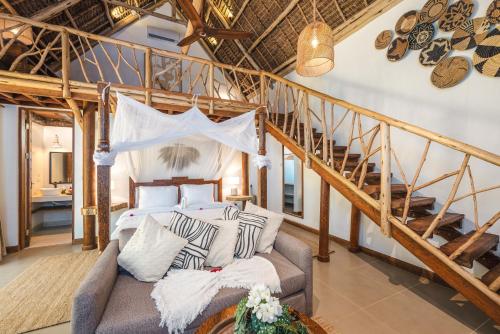 a bedroom with a bed and a staircase at Mala Boutique Hotel in Bwejuu