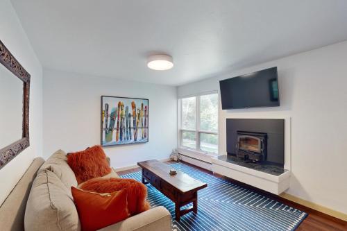 a living room with a couch and a fireplace at Alpine Escape in Edwards